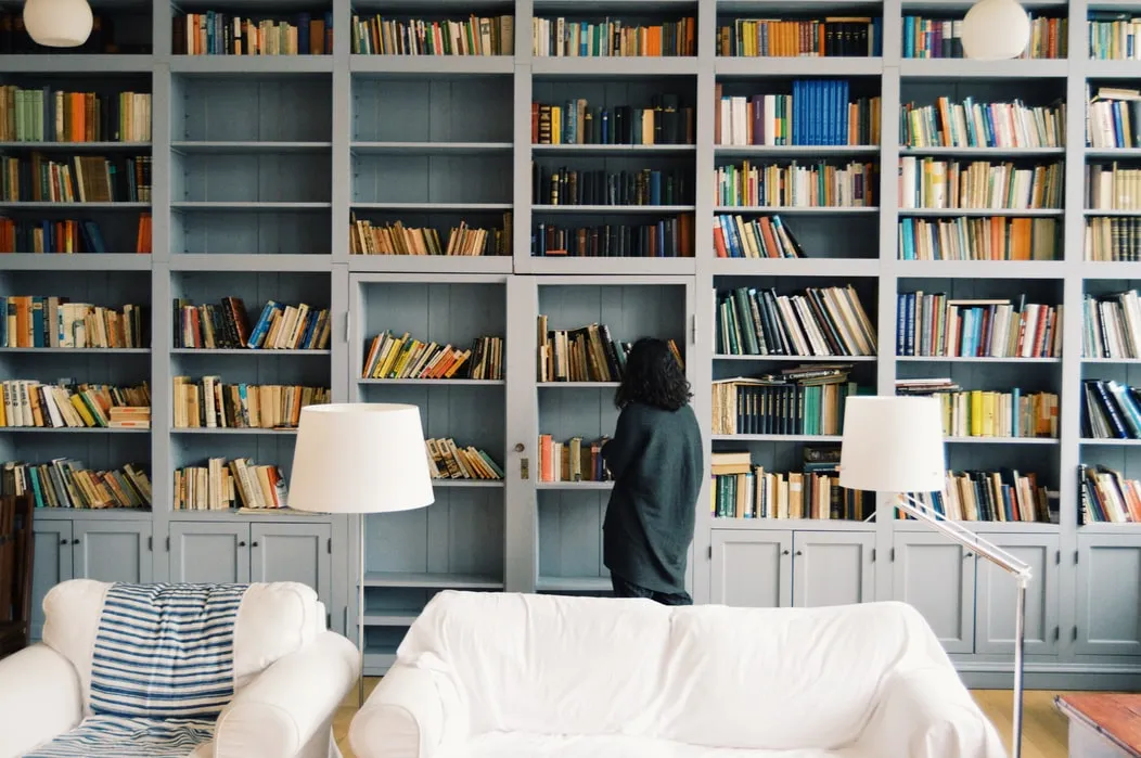a-woman-standing-in-front-of-house-library-photo-by-radu-marcusu-unsplash.jpg