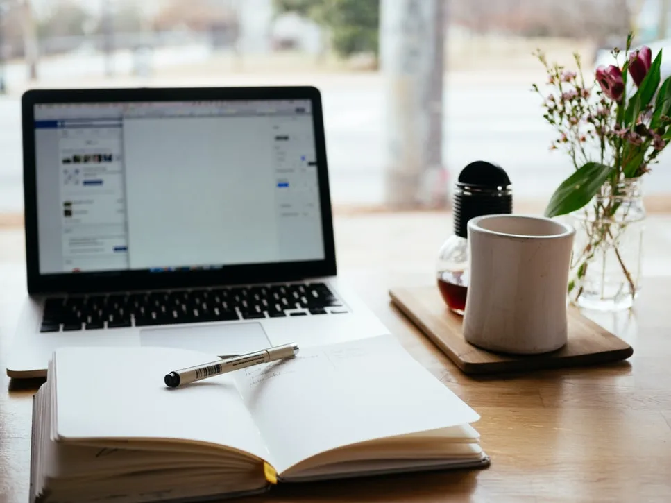 notebook-and-laptop-on-desk-by-nick-morisson-unsplash.jpg