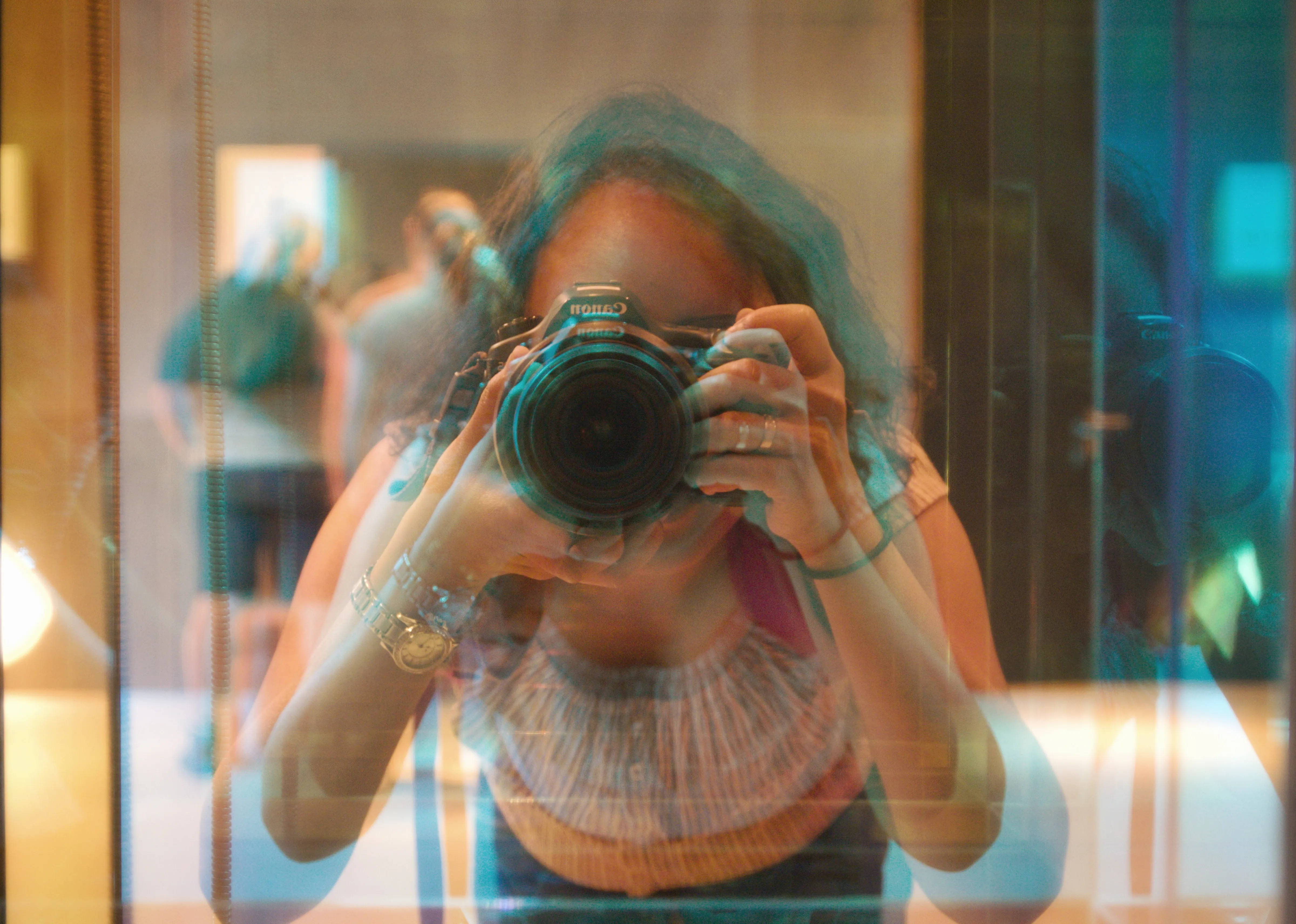 woman-hold-camera-in-front-of-a-prism-mirror.jpeg